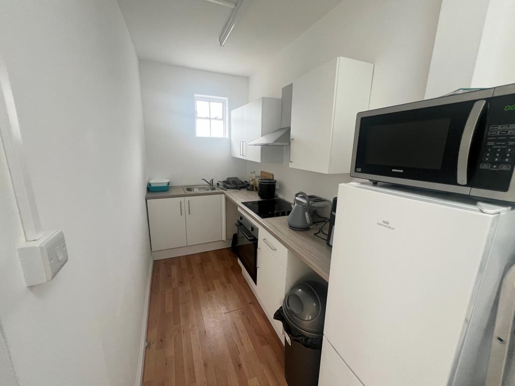 Lot: 35 - FORMER HOTEL FOR DEVELOPMENT POTENTIAL - downstairs kitchen to the rear of the property